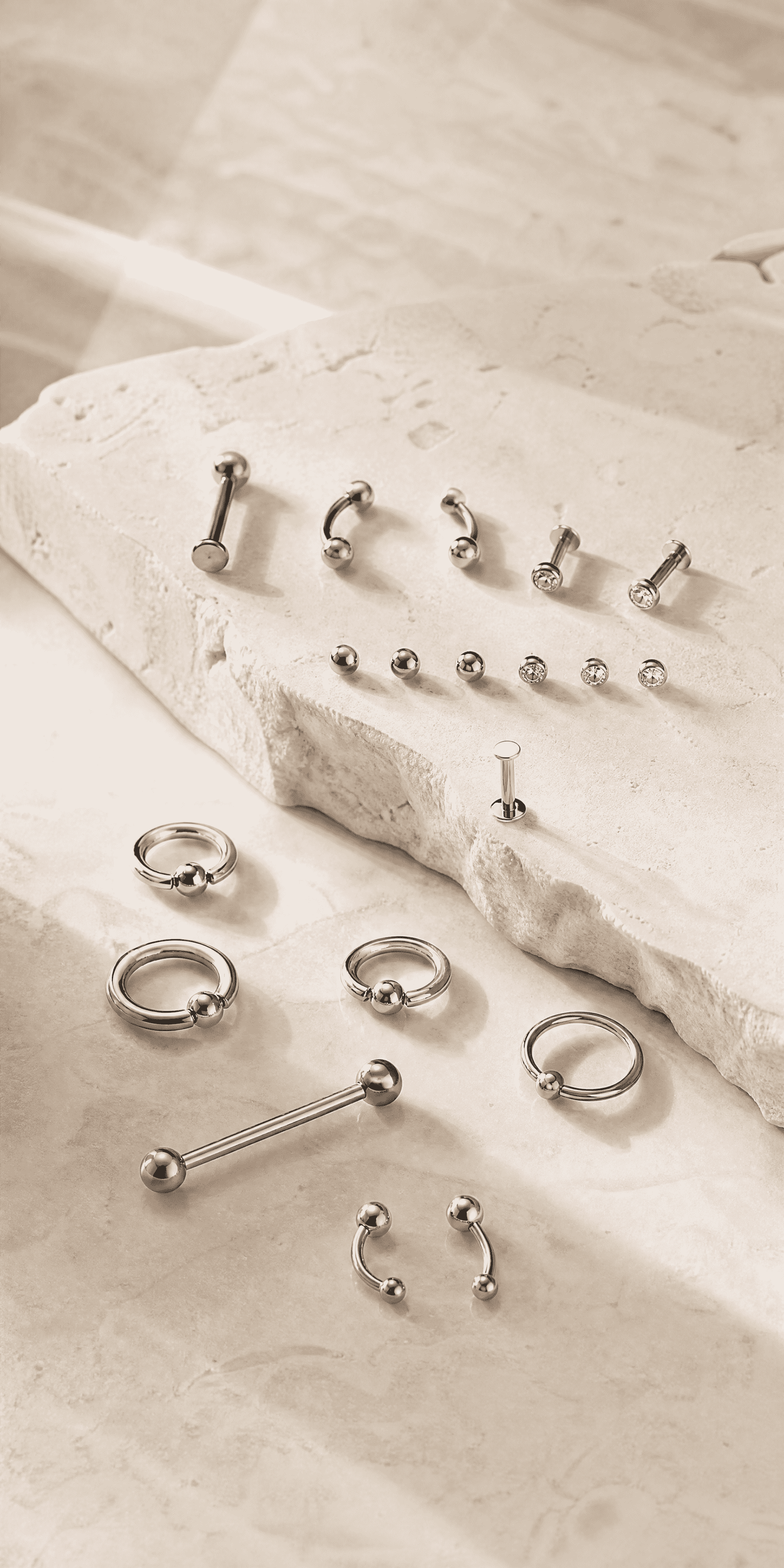Implant Titanium piercing pieces on stone surface